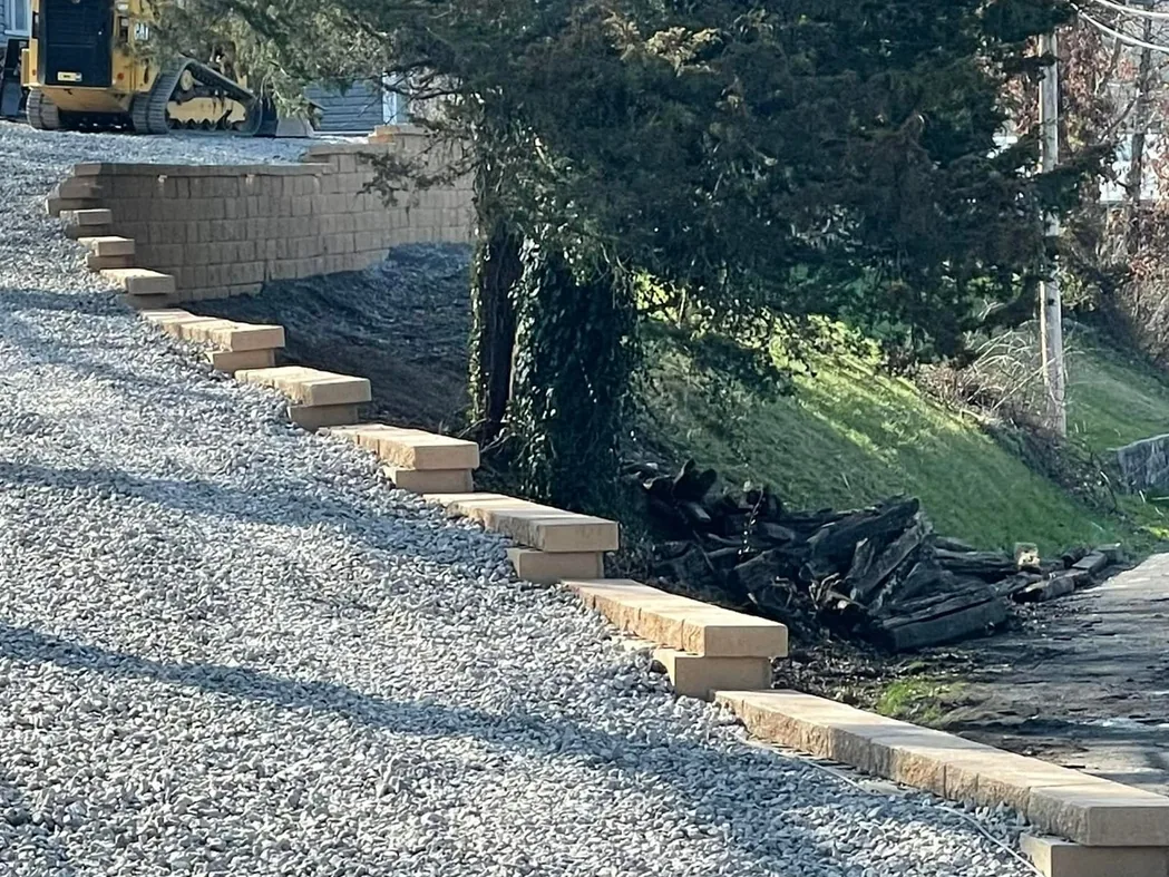 Gravel driveways: a graded gravel drive along a new block retaining wall with steps