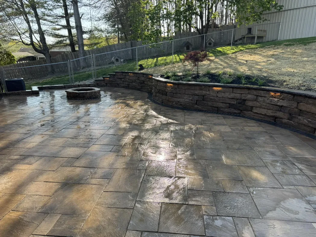Paver patios: a rectangular paver patio with a curved block seating wall and a fire pit