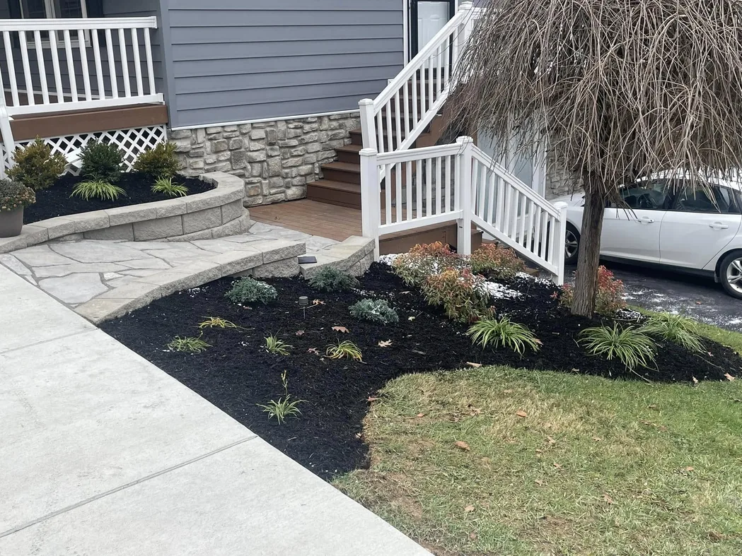 Walkways and steps: a flagstone paver walkway curving to porch steps past a new planting bed